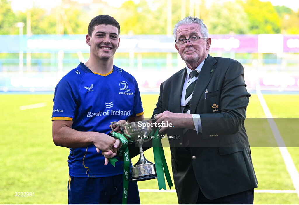 27 August 2025; IRFU Union Committee representative Robert Deacon presents the cup to Leinster captain Michael Smyth after the PwC U-18 Boys Schools Interprovincial Series match between Leinster and Ulster at Energia Park in Dublin. Photo by Piaras Ó Mídheach/Sportsfile