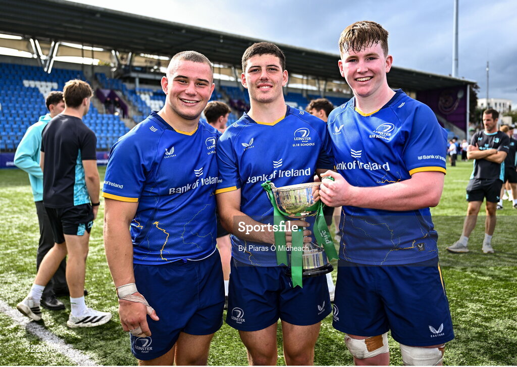 27 August 2025; Leinster players, from left, Herbie Boyle, Michael Smyth and Hugh Keaney with the cup after their side's victory in the PwC U-18 Boys Schools Interprovincial Series match between Leinster and Ulster at Energia Park in Dublin. Photo by Piaras Ó Mídheach/Sportsfile