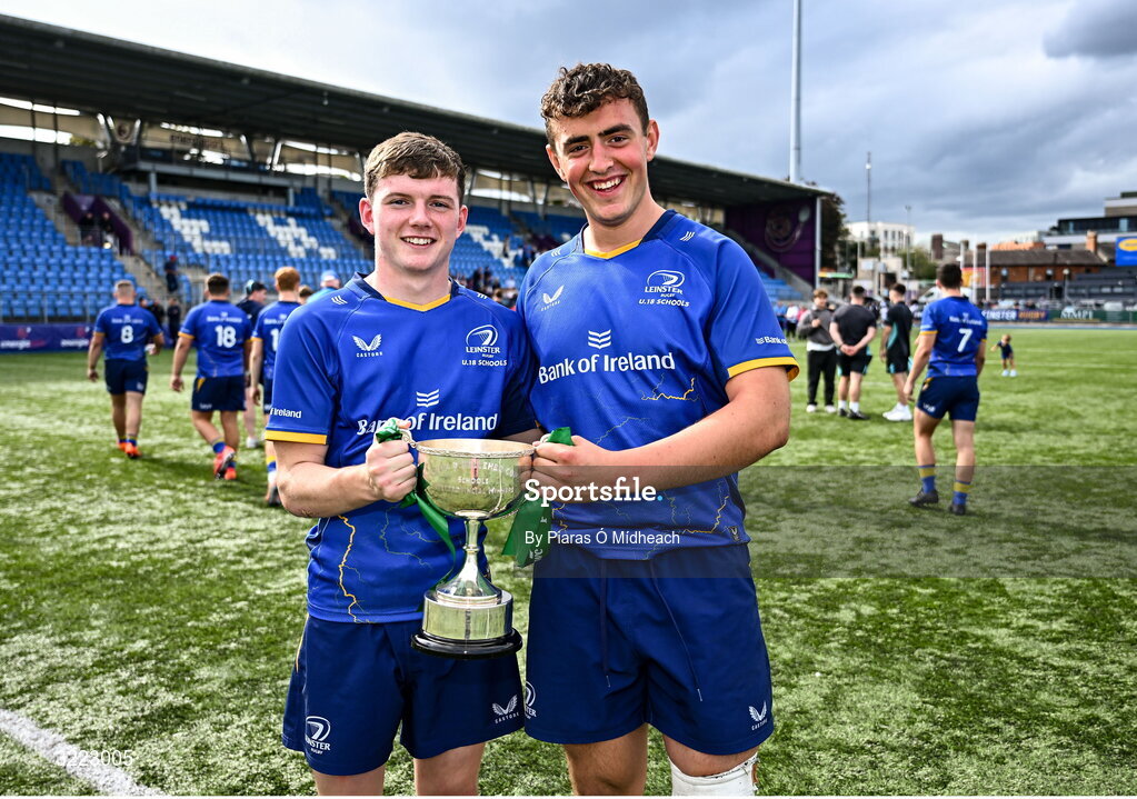 27 August 2025; Leinster players Tommy Smyth, left, and David Kenny celebrate with the trophy after their side's victory in the PwC U-18 Boys Schools Interprovincial Series match between Leinster and Ulster at Energia Park in Dublin. Photo by Piaras Ó Mídheach/Sportsfile