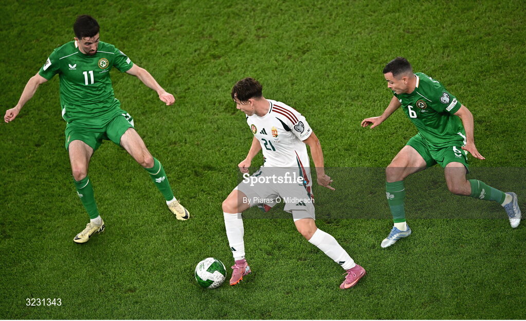 6 September 2025; Alex Tóth of Hungary in action against Republic of Ireland players Finn Azaz, left, and Josh Cullen during the FIFA World Cup 2026 Group F qualifying match between Republic of Ireland and Hungary at the Aviva Stadium in Dublin. Photo by Piaras Ó Mídheach/Sportsfile