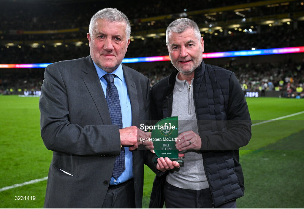 6 September 2025; FAI President Paul Cooke, left, presents former Republic of Ireland international Denis Irwin with his Hall of Fame award from the 35th FAI International Awards at half-time in the FIFA World Cup 2026 Group F qualifying match between Republic of Ireland and Hungary at the Aviva Stadium in Dublin. Photo by Stephen McCarthy/Sportsfile