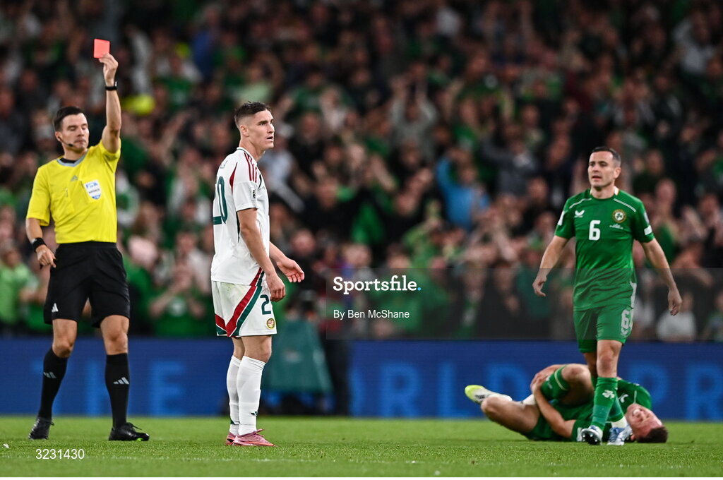 6 September 2025; Roland Sallai of Hungary is shown a red card by referee Harm Osmer after a foul on .i6, right, during the FIFA World Cup 2026 Group F qualifying match between Republic of Ireland and Hungary at the Aviva Stadium in Dublin. Photo by Ben McShane/Sportsfile