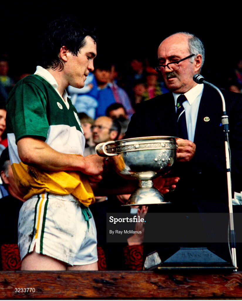 13 July 1986; Offaly captain Michael Hogan is presented with the Hanrahan Cup by Leinster Council Chairman Peadar O Cearnaigh after his sides victory in the Leinster Minor Hurling Championship Final match between Offaly and Wexford at Croke Park, Dublin. Photo by Ray McManus/Sportsfile