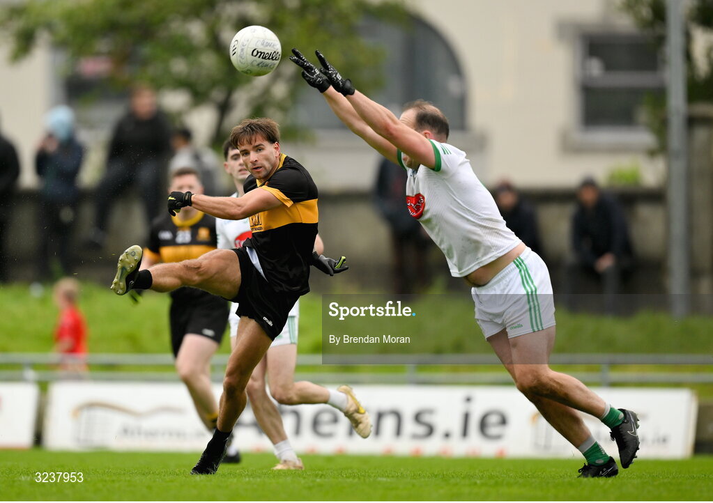 14 September 2025; Micheal Burns of Dr Crokes kicks a point despite the efforts of Andrew Barry of Na Gaeil during the Kerry County Senior Club Football Championship final match between Dr Crokes and Na Gaeil at Austin Stack Park in Tralee, Kerry. Photo by Brendan Moran/Sportsfile