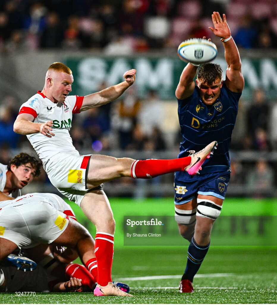 26 September 2025; Nathan Doak of Ulster kicks clear despite the efforts of Shane Lewis-Hughes of Dragons during the United Rugby Championship match between Ulster and Dragons at Affidea Stadium in Belfast. Photo by Shauna Clinton/Sportsfile