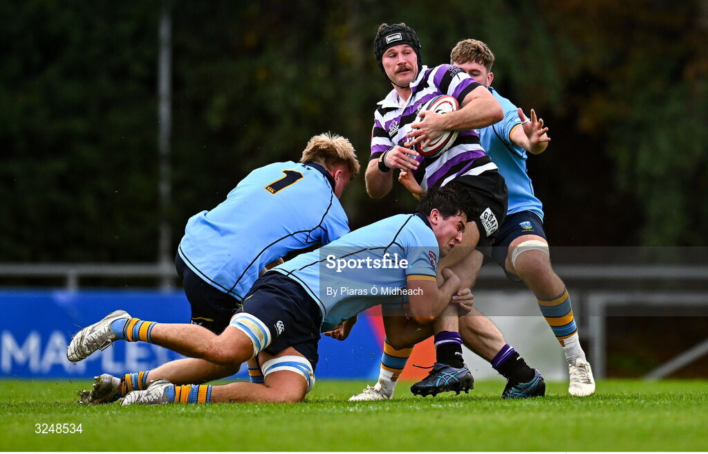 27 September 2025; Ethan Reily of Terenure College RFC is tackled by Tom O'Riordan, 1, and Daniel Barron, centre, of UCD during the Energia All-Ireland League Division 1A match between UCD and Terenure College RFC at UCD Bowl in Dublin. Photo by Piaras Ó Mídheach/Sportsfile