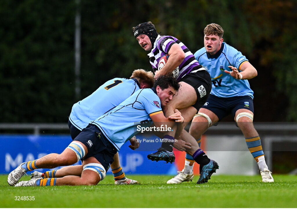 27 September 2025; Ethan Reily of Terenure College RFC is tackled by Tom O'Riordan, 1, and Daniel Barron, centre, of UCD during the Energia All-Ireland League Division 1A match between UCD and Terenure College RFC at UCD Bowl in Dublin. Photo by Piaras Ó Mídheach/Sportsfile