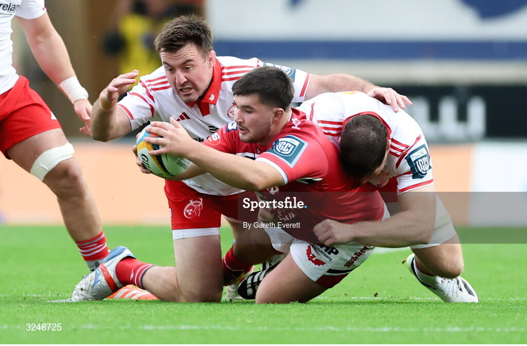 27 September 2025; Harry Thomas of Scarlets is tackled during the United Rugby Championship match between Scarlets and Munster at Parc Y Scarlets in Llanelli, Wales. Photo by Gareth Everett/Sportsfile