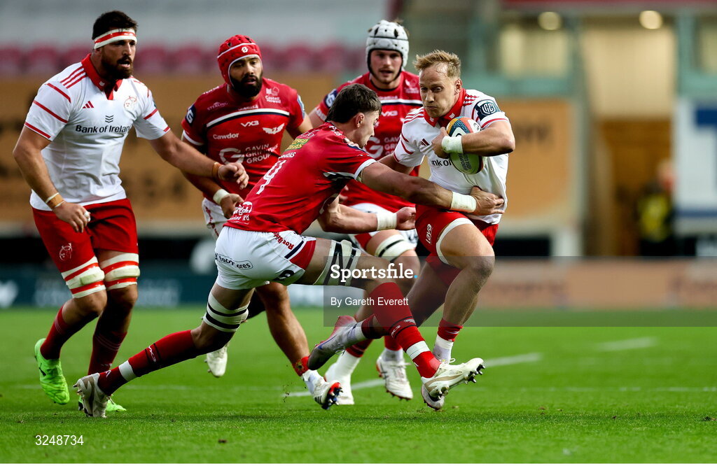 27 September 2025; Mike Haley of Munster is tackled by Sam Lousi of Scarlets during the United Rugby Championship match between Scarlets and Munster at Parc Y Scarlets in Llanelli, Wales. Photo by Gareth Everett/Sportsfile