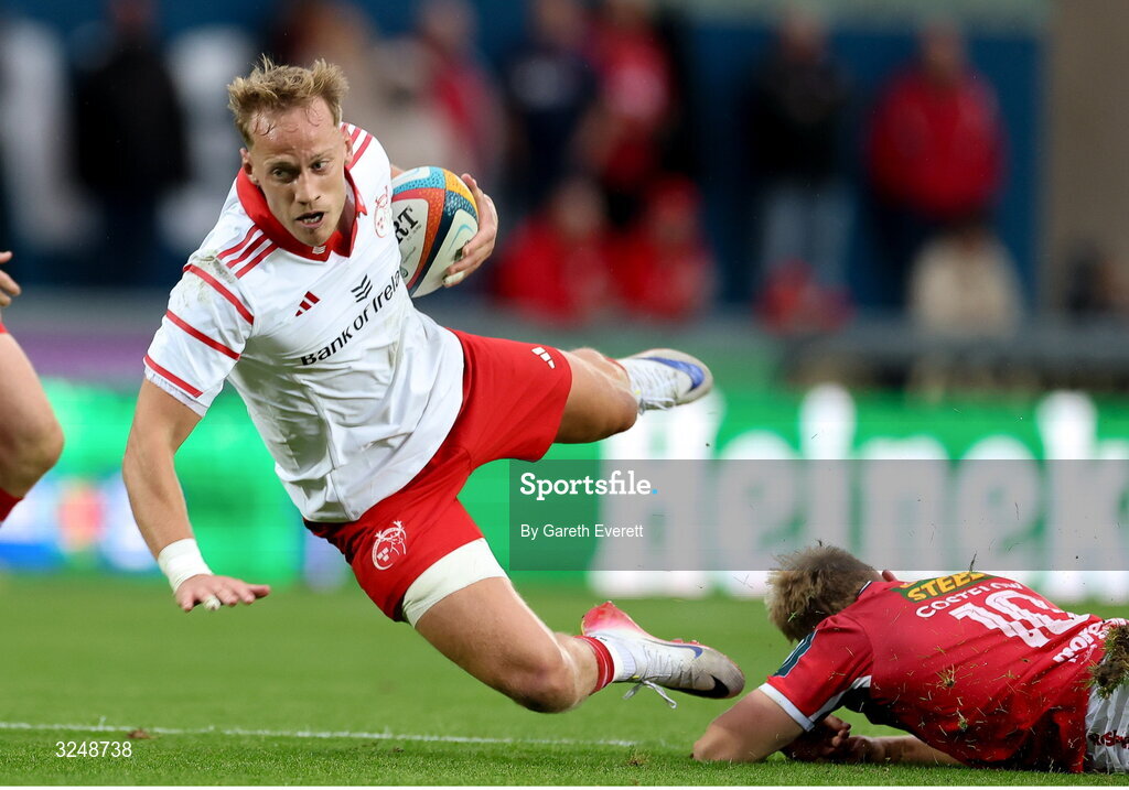 27 September 2025; Mike Haley of Munster is tackled during the United Rugby Championship match between Scarlets and Munster at Parc Y Scarlets in Llanelli, Wales. Photo by Gareth Everett/Sportsfile