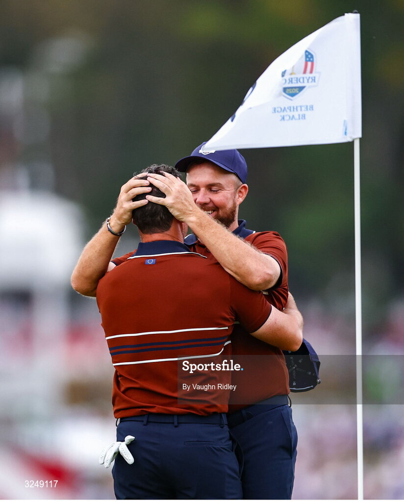 27 September 2025; Rory McIlroy of Europe, left, and Shane Lowry of Europe celebrate on the 18th green after winning in the afternoon fourballs on day two of the 2025 Ryder Cup at Black Course at Bethpage State Park Golf Course in Farmingdale, New York, USA. Photo by Vaughn Ridley/Sportsfile