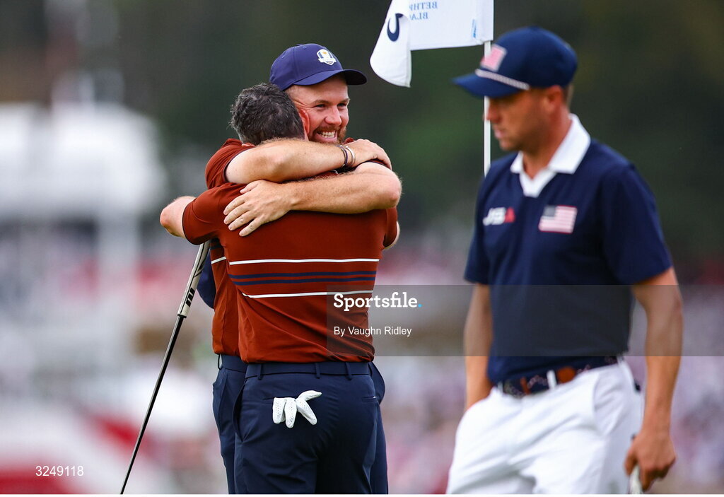 27 September 2025; Rory McIlroy of Europe, left, and Shane Lowry of Europe celebrate on the 18th green after winning in the afternoon fourballs on day two of the 2025 Ryder Cup at Black Course at Bethpage State Park Golf Course in Farmingdale, New York, USA. Photo by Vaughn Ridley/Sportsfile