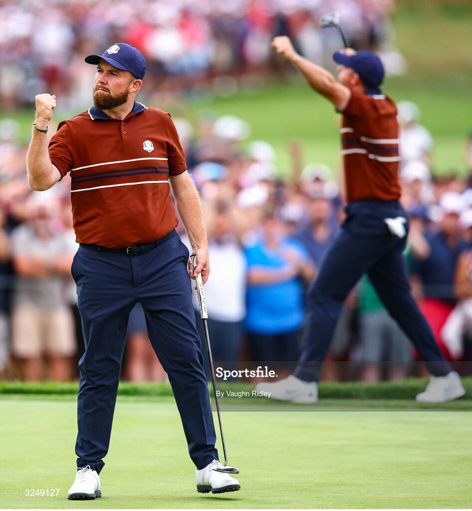 27 September 2025; Shane Lowry of Europe, left, and Rory McIlroy of Europe celebrate on the 17th green during the afternoon fourballs on day two of the 2025 Ryder Cup at Black Course at Bethpage State Park Golf Course in Farmingdale, New York, USA. Photo by Vaughn Ridley/Sportsfile