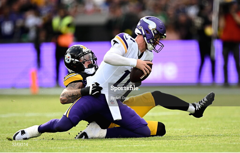 28 September 2025; Quarterback Carson Wentz #11 of Minnesota Vikings is tackled by Linebacker Nick Herbig #51 of Pittsburgh Steelers during the 2025 NFL International Game between the Pittsburgh Steelers and the Minnesota Vikings at Croke Park in Dublin. Photo by Seb Daly/Sportsfile