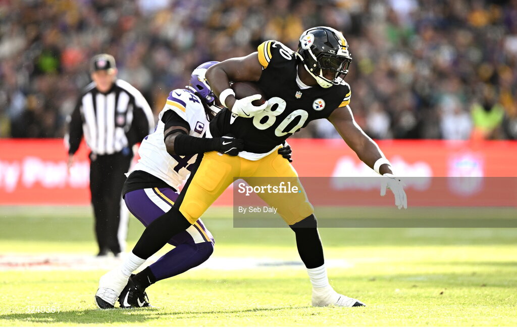 28 September 2025; Tight end Darnell Washington #80 of Pittsburgh Steelers is tackled by Safety Joshua Metellus #44 of Minnesota Vikings during the 2025 NFL International Game between the Pittsburgh Steelers and the Minnesota Vikings at Croke Park in Dublin. Photo by Seb Daly/Sportsfile