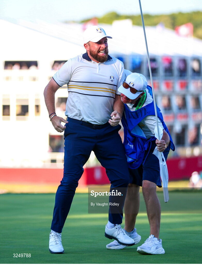 28 September 2025; Shane Lowry of Europe celebrates with his caddie Darren Reynolds on the 18th green during the singles matches on day three of the 2025 Ryder Cup at Black Course at Bethpage State Park Golf Course in Farmingdale, New York, USA. Photo by Vaughn Ridley/Sportsfile