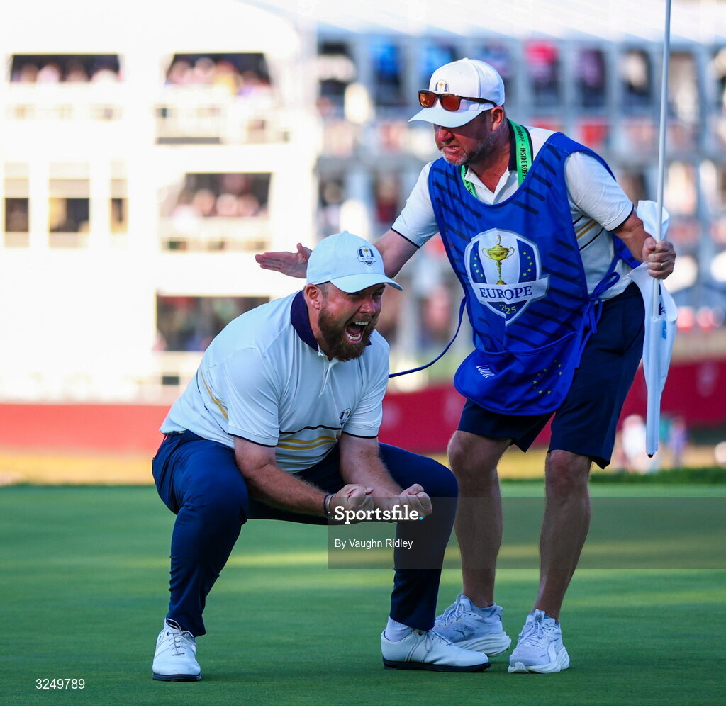 28 September 2025; Shane Lowry of Europe celebrates with his caddie Darren Reynolds on the 18th green during the singles matches on day three of the 2025 Ryder Cup at Black Course at Bethpage State Park Golf Course in Farmingdale, New York, USA. Photo by Vaughn Ridley/Sportsfile