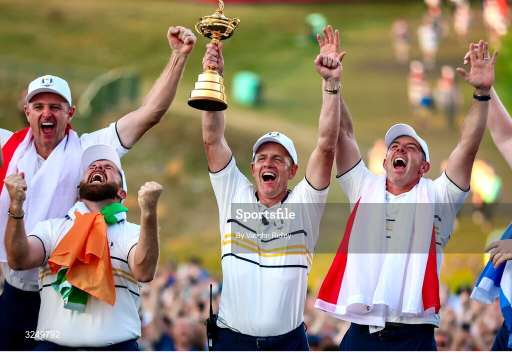 28 September 2025; Europe captain Luke Donald lifts the Ryder Cup alongside Shane Lowry and Rory McIlroy on day three of the 2025 Ryder Cup at Black Course at Bethpage State Park Golf Course in Farmingdale, New York, USA. Photo by Vaughn Ridley/Sportsfile