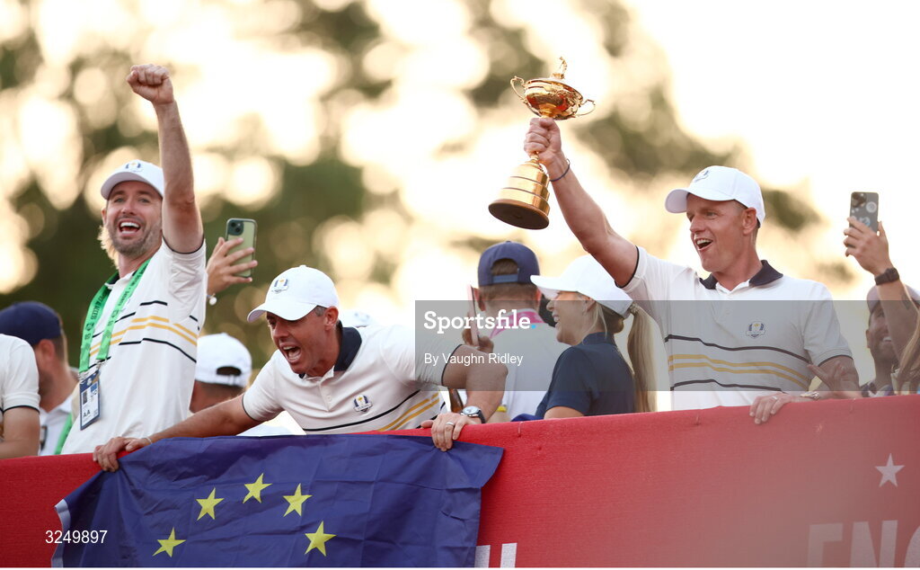 28 September 2025; Europe captain Luke Donald celebrates with the Ryder Cup alongside Rory McIlroy, centre, on day three of the 2025 Ryder Cup at Black Course at Bethpage State Park Golf Course in Farmingdale, New York, USA. Photo by Vaughn Ridley/Sportsfile