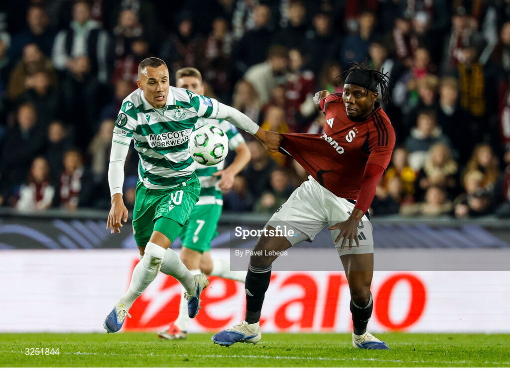 2 October 2025; Graham Burke of Shamrock Rovers in action against Emmanuel Uchenna of Sparta Praha during the UEFA Conference League 2025/26 league phase match between Sparta Praha and Shamrock Rovers at epet ARENA in Prague, Czechia. Photo by Pavel Lebeda/Sportsfile