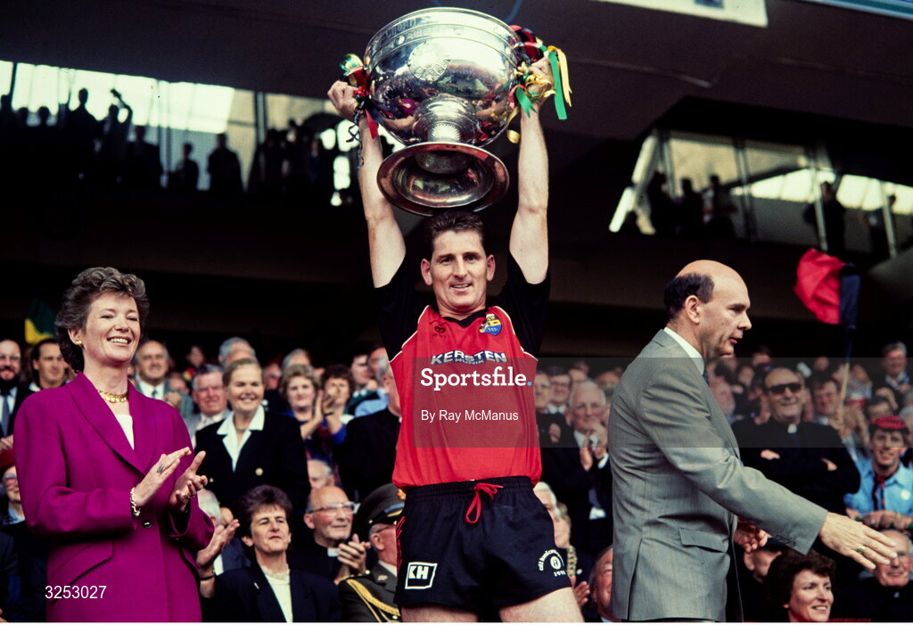 15 September 1991; Down captain Paddy O'Rourke lifts the Sam Maguire Cup, in the company of President of Ireland Mary Robinson, left, and GAA President Peter Quinn after the All-Ireland Senior Football Championship Final between Down and Meath at Croke Park in Dublin. Photo by Ray McManus/Sportsfile