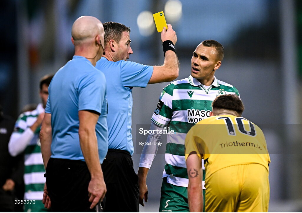 5 October 2025; Graham Burke of Shamrock Rovers is shown a yellow card by referee Paul McLaughlin during the Sports Direct Men’s FAI Cup semi-final match between Shamrock Rovers and Kerry FC at Tallaght Stadium in Dublin. Photo by Seb Daly/Sportsfile