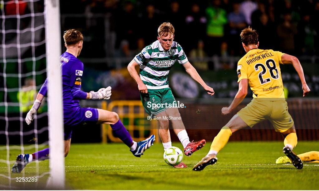 5 October 2025; Michael Noonan of Shamrock Rovers scores his side's fifth goal past Kerry FC goalkeeper Darragh Foley, left, and Niall Brookwell of Kerry FC during the Sports Direct Men’s FAI Cup semi-final match between Shamrock Rovers and Kerry FC at Tallaght Stadium in Dublin. Photo by Ben McShane/Sportsfile