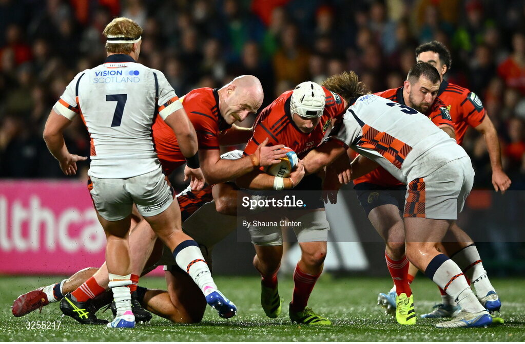 10 October 2025; Fineen Wycherly of Munster is tackled by Edinburgh players Pierre Schoeman, left, and D'arcy Rae during the United Rugby Championship match between Munster and Edinburgh at Virgin Media Park in Cork. Photo by Shauna Clinton/Sportsfile