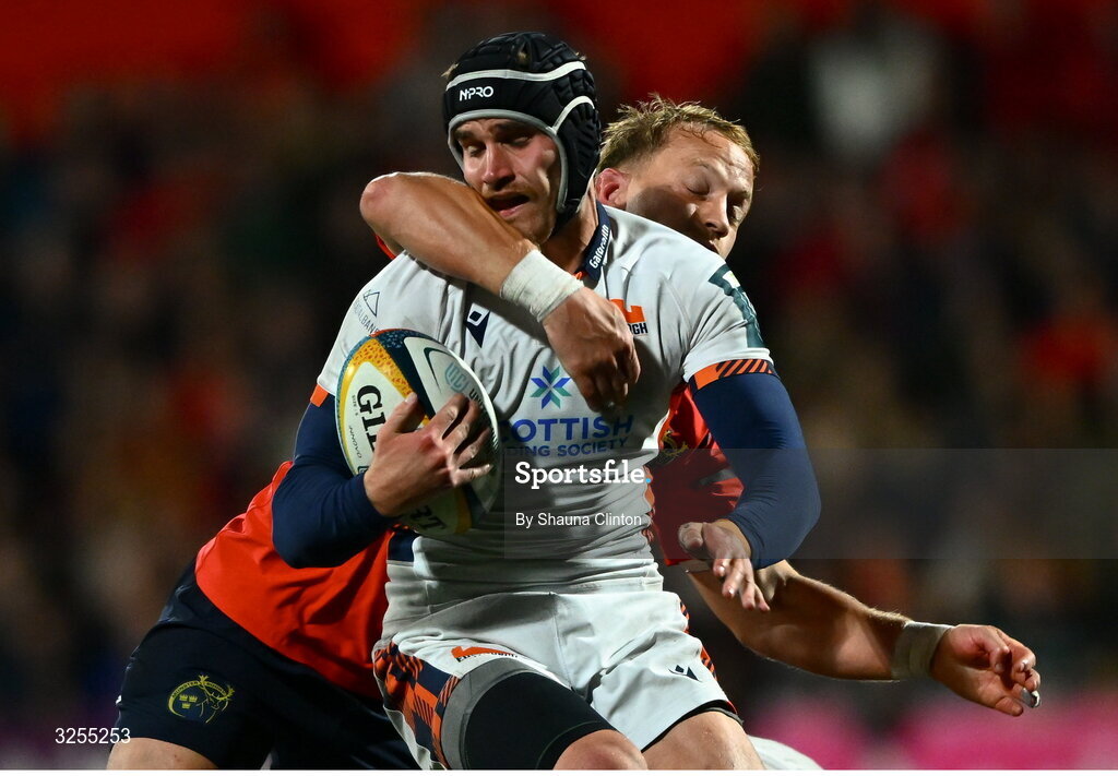 10 October 2025; James Lang of Edinburgh is tackled by Mike Haley of Munster during the United Rugby Championship match between Munster and Edinburgh at Virgin Media Park in Cork. Photo by Shauna Clinton/Sportsfile
