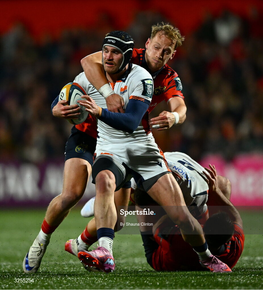 10 October 2025; James Lang of Edinburgh is tackled by Mike Haley of Munster during the United Rugby Championship match between Munster and Edinburgh at Virgin Media Park in Cork. Photo by Shauna Clinton/Sportsfile
