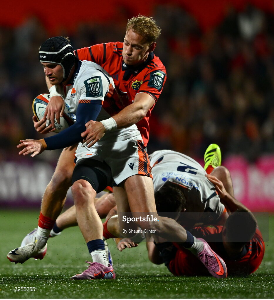 10 October 2025; James Lang of Edinburgh is tackled by Mike Haley of Munster during the United Rugby Championship match between Munster and Edinburgh at Virgin Media Park in Cork. Photo by Shauna Clinton/Sportsfile