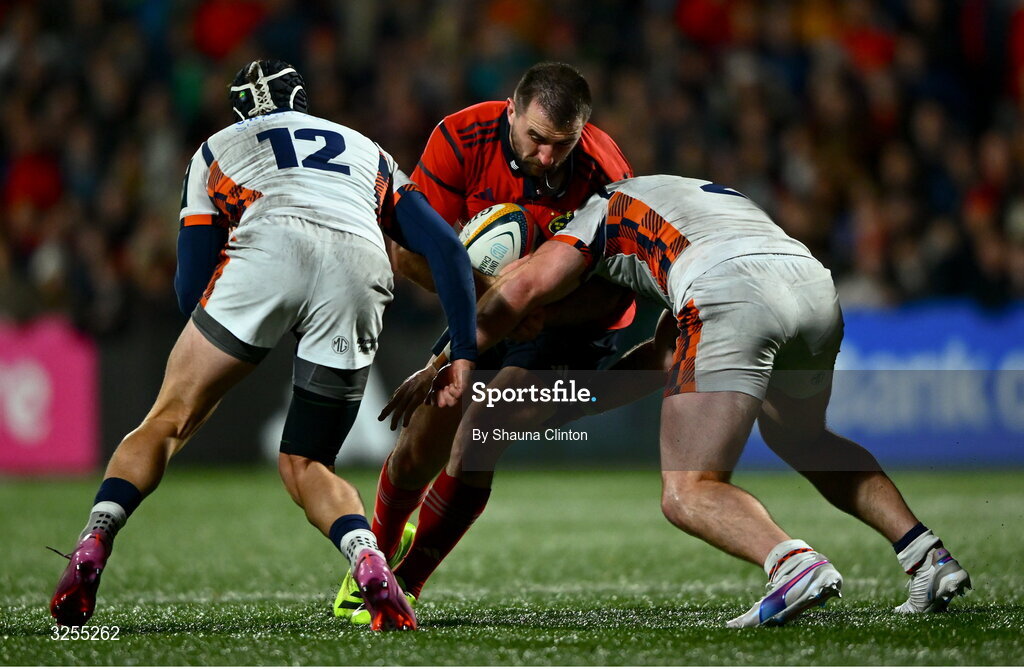 10 October 2025; Diarmuid Barron of Munster is tackled by Edinburgh players James Lang, left, and Ewan Ashman during the United Rugby Championship match between Munster and Edinburgh at Virgin Media Park in Cork. 10 October 2025; Diarmuid Barron of Munster is tackled by Edinburgh players James Lang, left, and Ewan Ashman during the United Rugby Championship match between Munster and Edinburgh at Virgin Media Park in Cork. Photo by Shauna Clinton/Sportsfile