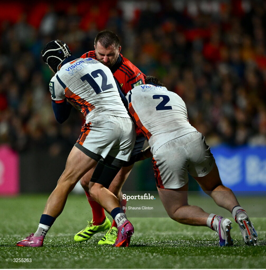 10 October 2025; Diarmuid Barron of Munster is tackled by Edinburgh players James Lang, left, and Ewan Ashman during the United Rugby Championship match between Munster and Edinburgh at Virgin Media Park in Cork. 10 October 2025; Diarmuid Barron of Munster is tackled by Edinburgh players James Lang, left, and Ewan Ashman during the United Rugby Championship match between Munster and Edinburgh at Virgin Media Park in Cork. Photo by Shauna Clinton/Sportsfile