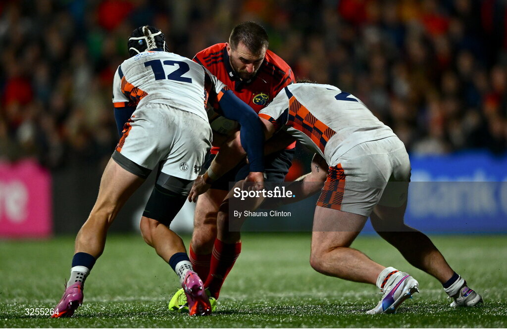 10 October 2025; Diarmuid Barron of Munster is tackled by Edinburgh players James Lang, left, and Ewan Ashman during the United Rugby Championship match between Munster and Edinburgh at Virgin Media Park in Cork. 10 October 2025; Diarmuid Barron of Munster is tackled by Edinburgh players James Lang, left, and Ewan Ashman during the United Rugby Championship match between Munster and Edinburgh at Virgin Media Park in Cork. Photo by Shauna Clinton/Sportsfile