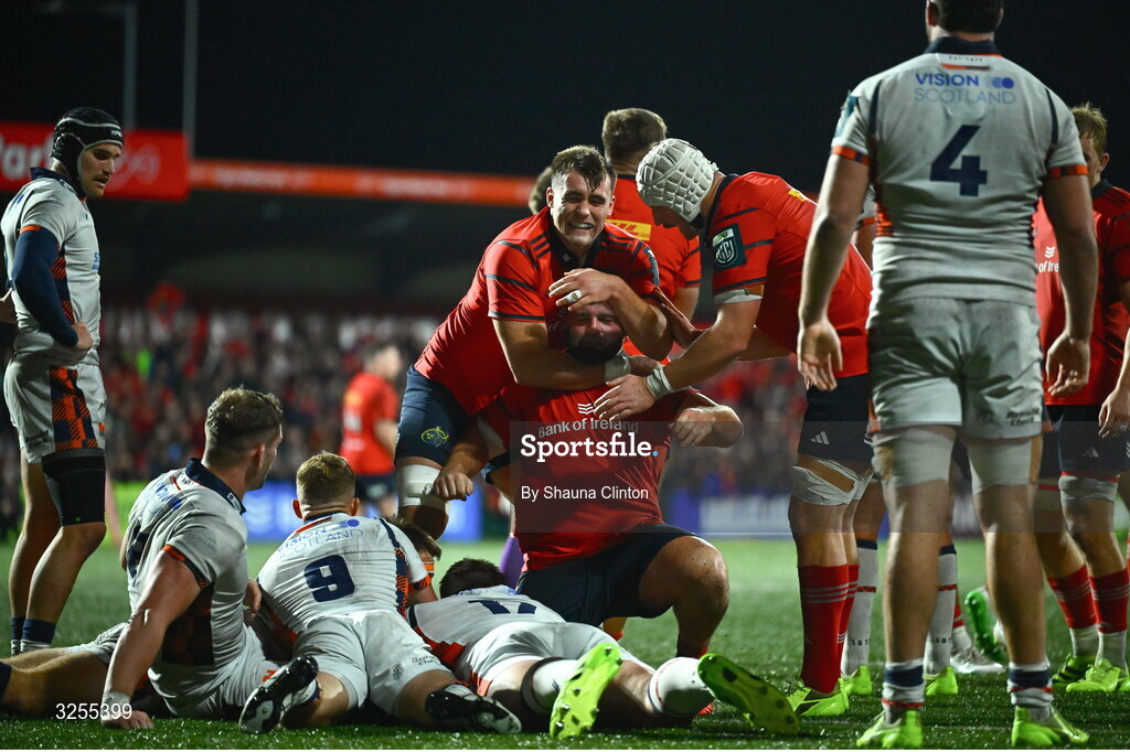 10 October 2025; Michael Milne of Munster, centre, celebrates after scoring his side's third try during the United Rugby Championship match between Munster and Edinburgh at Virgin Media Park in Cork. Photo by Shauna Clinton/Sportsfile
