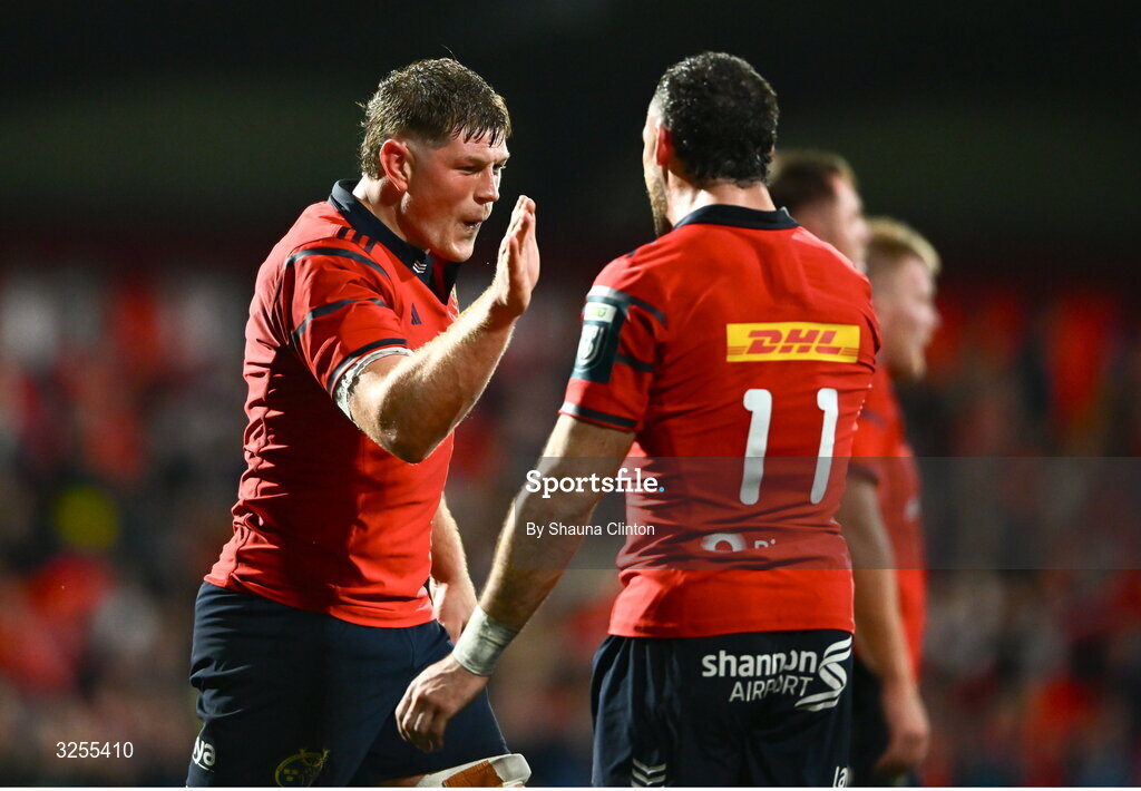 10 October 2025; Jack O'Donoghue of Munster, left, celebrates with team-mate Andrew Smith during the United Rugby Championship match between Munster and Edinburgh at Virgin Media Park in Cork. Photo by Shauna Clinton/Sportsfile