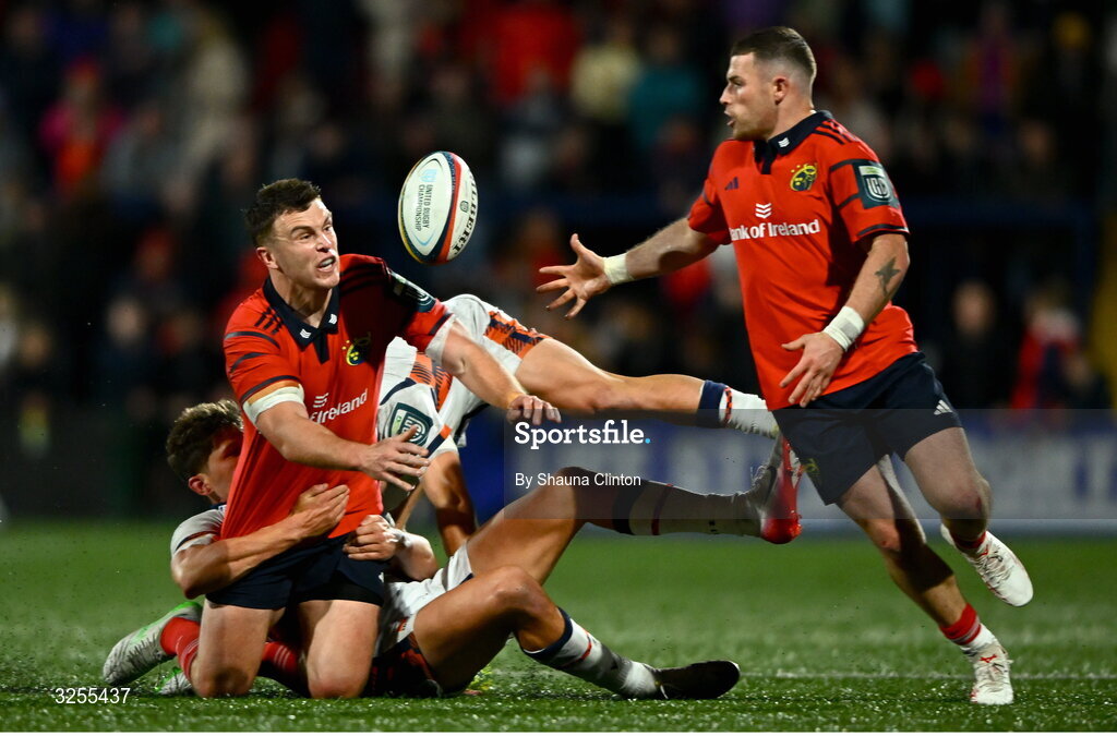 10 October 2025; Tom Farrell of Munster offloads the ball to team-mate Calvin Nash despite the tackle of Piers O'Conor, left, and Darcy Graham of Edinburgh during the United Rugby Championship match between Munster and Edinburgh at Virgin Media Park in Cork. Photo by Shauna Clinton/Sportsfile
