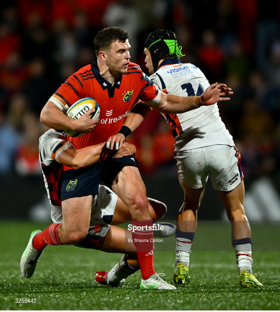 10 October 2025; Tom Farrell of Munster is tackled by Piers O'Conor, left, and Darcy Graham of Edinburgh during the United Rugby Championship match between Munster and Edinburgh at Virgin Media Park in Cork. Photo by Shauna Clinton/Sportsfile