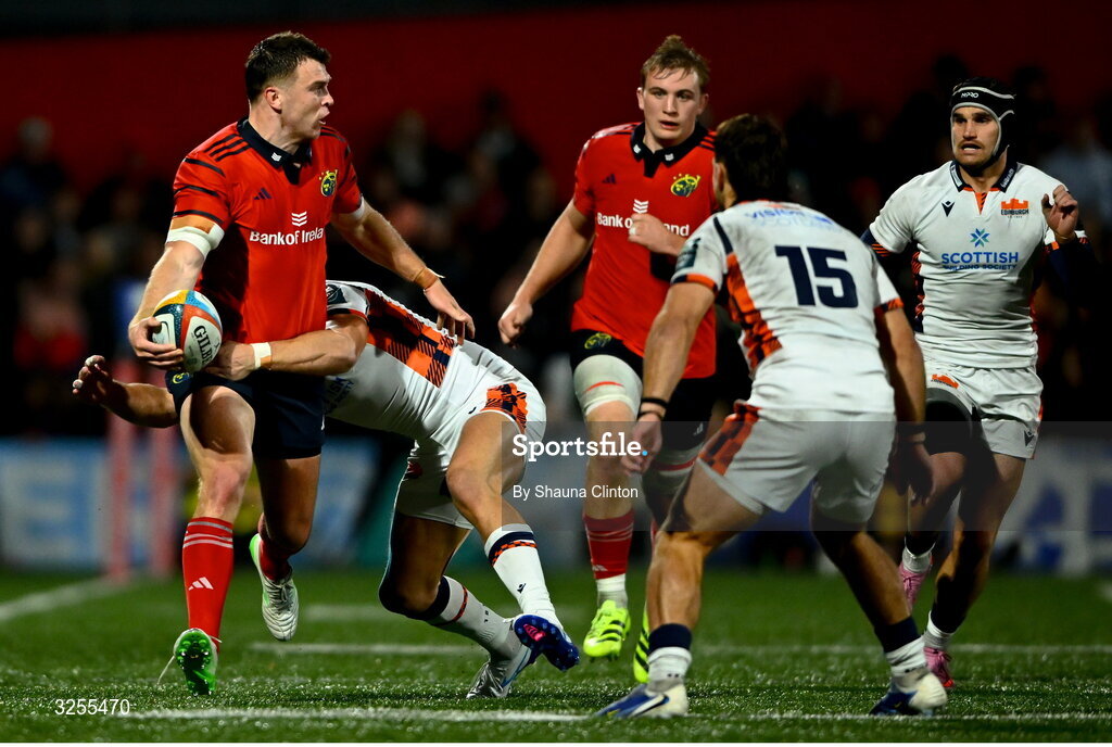 10 October 2025; Tom Farrell of Munster is tackled by James Lang of Edinburgh during the United Rugby Championship match between Munster and Edinburgh at Virgin Media Park in Cork. Photo by Shauna Clinton/Sportsfile