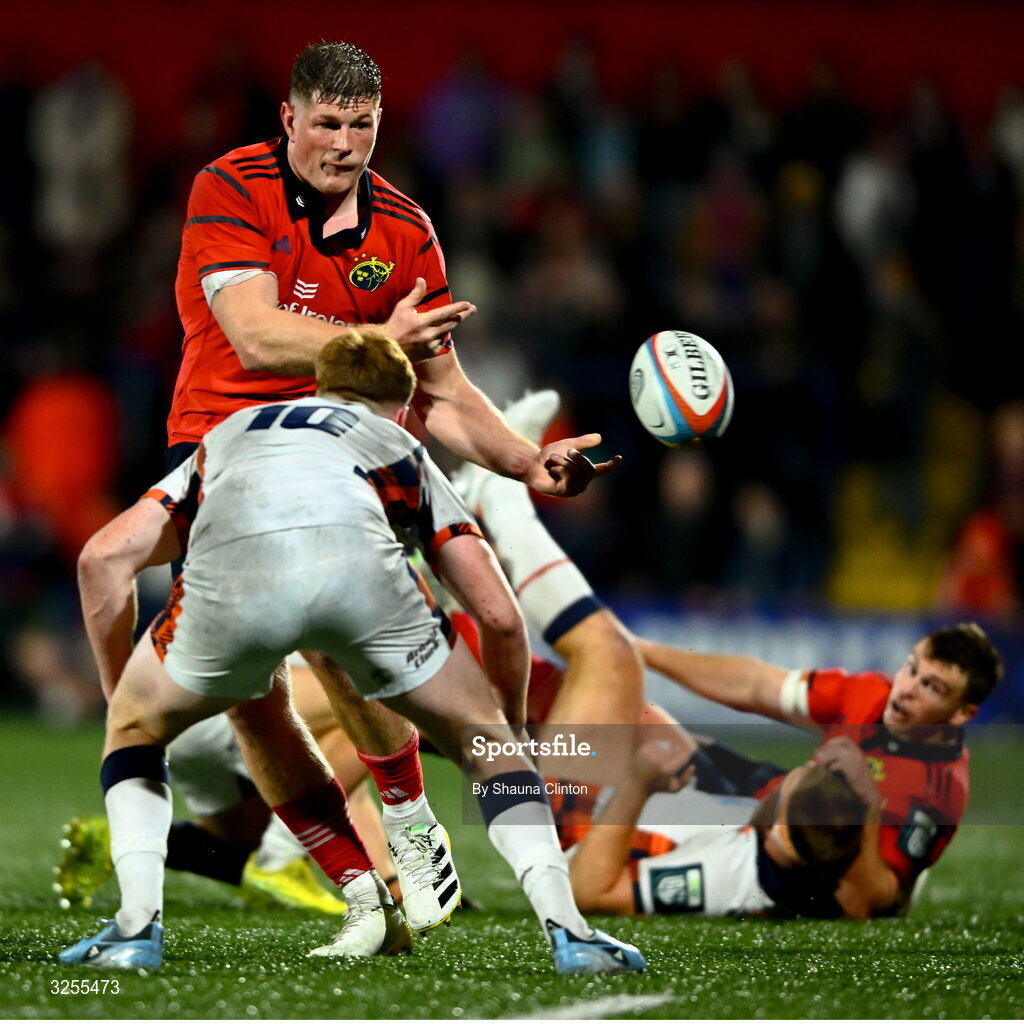 10 October 2025; Jack O'Donoghue of Munster offloads the ball despite the attention of Ben Healy of Edinburgh during the United Rugby Championship match between Munster and Edinburgh at Virgin Media Park in Cork. Photo by Shauna Clinton/Sportsfile