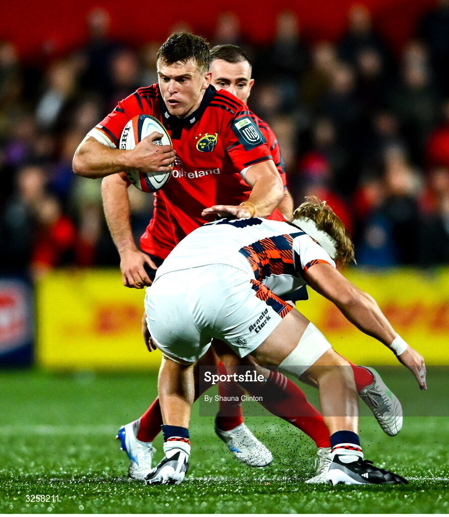 10 October 2025; Tom Farrell of Munster is tackled by Ben Healy of Edinburgh during the United Rugby Championship match between Munster and Edinburgh at Virgin Media Park in Cork. Photo by Shauna Clinton/Sportsfile