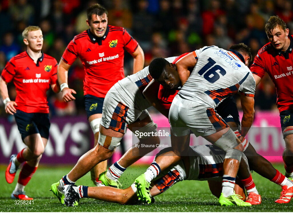 10 October 2025; Edwin Edogbo of Munster is tackled by Edinburgh players Marshall Sykes, left, and Paddy Harrison during the United Rugby Championship match between Munster and Edinburgh at Virgin Media Park in Cork. Photo by Shauna Clinton/Sportsfile