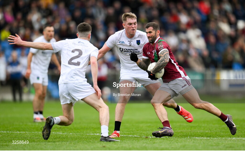 12 October 2025; Jason Moore of Portarlington in action against Darragh McEvoy and Robert Tyrrell of Courtwood during the Laois County Senior Club Football Championship final match between Courtwood and Portarlington at Laois Hire O'Moore Park in Portlaoise, Laois. Photo by Brendan Moran/Sportsfile