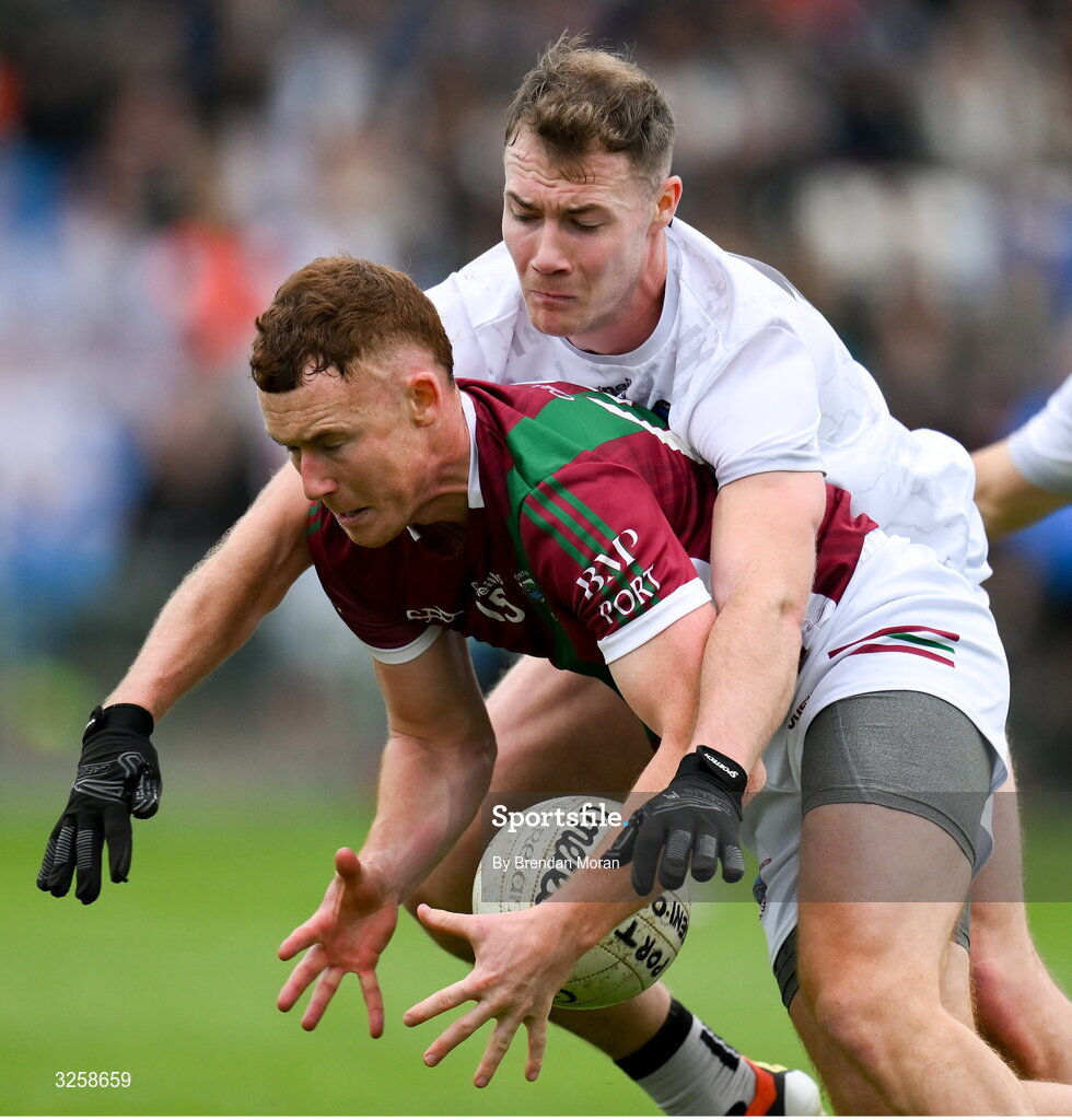 12 October 2025; Jake Foster of Portarlington is tackled by Niall Dunne of Courtwood during the Laois County Senior Club Football Championship final match between Courtwood and Portarlington at Laois Hire O'Moore Park in Portlaoise, Laois. Photo by Brendan Moran/Sportsfile