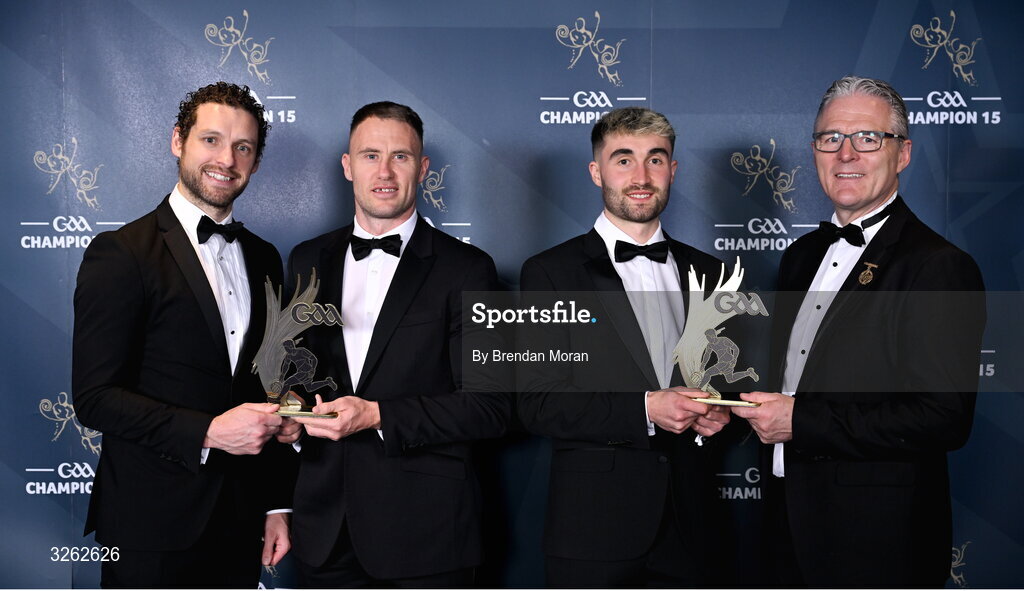 17 October 2025; GPA Chief Executive Officer Tom Parsons, left, and Uachtarán Chumann Lúthchleas Gael Jarlath Burns, right, present Wickloiw footballers Dean Healy, second from left, and Malachy Stone with their 2025 Tailteann Cup Team of the Year awards during the GAA Champion 15 Awards ceremony at Croke Park in Dublin. Photo by Brendan Moran/Sportsfile