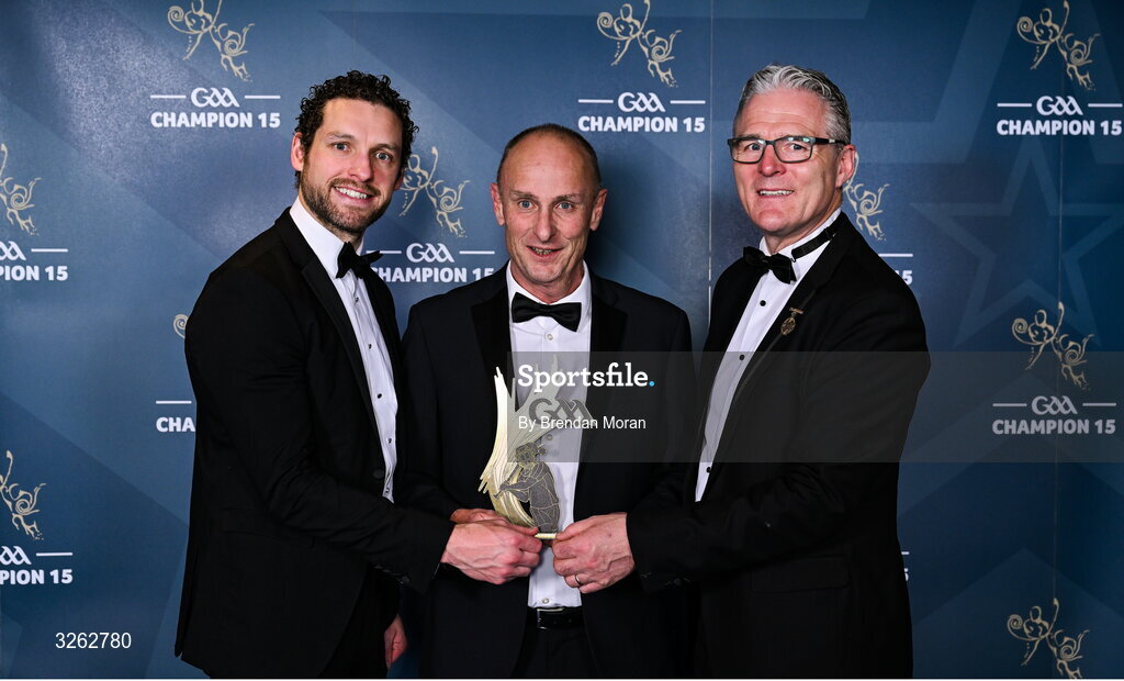 17 October 2025; Joseph Mangan accepts a 2025 Ring, Rackard, and Meagher Team of the Year award on behalf of his son David Mangan of New York from GPA Chief Executive Officer Tom Parsons, left, and Uachtarán Chumann Lúthchleas Gael Jarlath Burns, right, during the GAA Champion 15 Awards ceremony at Croke Park in Dublin. Photo by Brendan Moran/Sportsfile