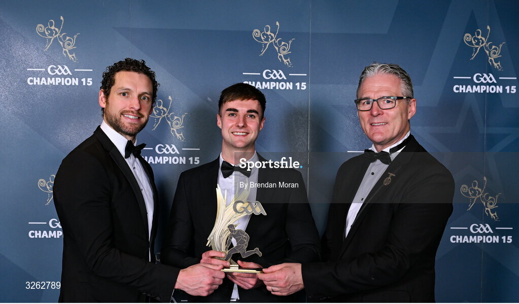 17 October 2025; Wexford footballer Sean Nolan receives his 2025 Tailteann Cup Team of the Year award from GPA Chief Executive Officer Tom Parsons, left, and Uachtarán Chumann Lúthchleas Gael Jarlath Burns, right, during the GAA Champion 15 Awards ceremony at Croke Park in Dublin. Photo by Brendan Moran/Sportsfile