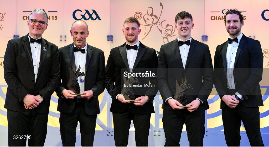17 October 2025; Uachtarán Chumann Lúthchleas Gael Jarlath Burns, left, and GPA Chief Executive Officer Tom Parsons, right, present Joseph Mangan, representing his son David Mangan of New York, second from left, Sean Glynn of London, and Liam O'Brien of Cavan with their 2025 Ring, Rackard, and Meagher Team of the Year awards during the GAA Champion 15 Awards ceremony at Croke Park in Dublin. Photo by Brendan Moran/Sportsfile