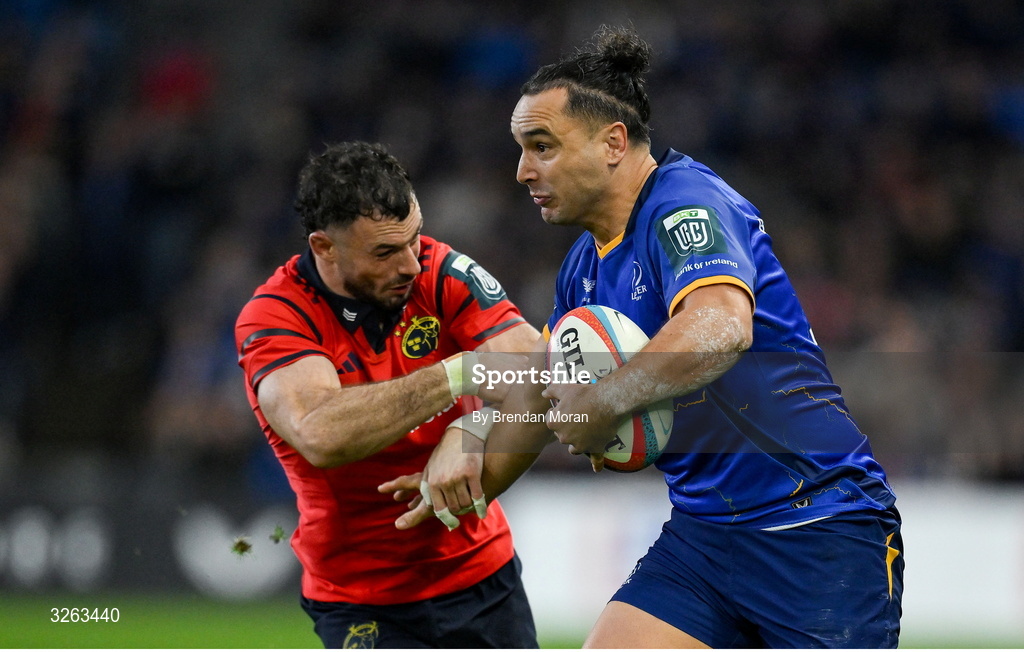 18 October 2025; James Lowe of Leinster in action against Andrew Smith of Munster during the United Rugby Championship match between Leinster and Munster at Croke Park in Dublin. Photo by Brendan Moran/Sportsfile