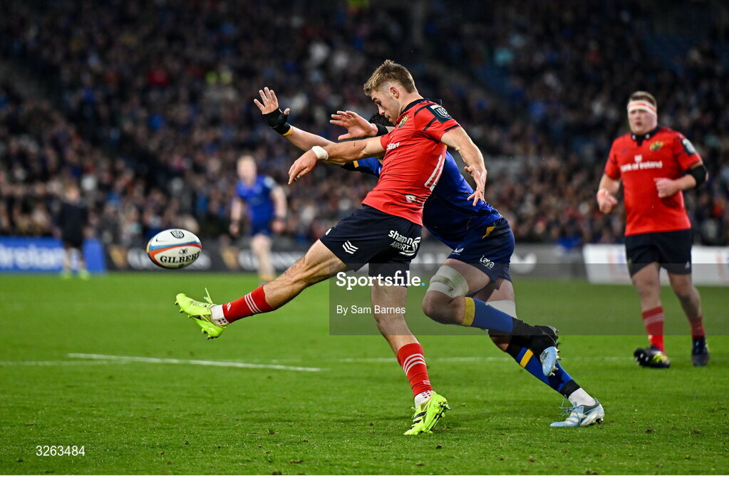 18 October 2025; Jack Crowley of Munster kicks clear ahead of Alex Soroka of Leinster during the United Rugby Championship match between Leinster and Munster at Croke Park in Dublin. Photo by Sam Barnes/Sportsfile